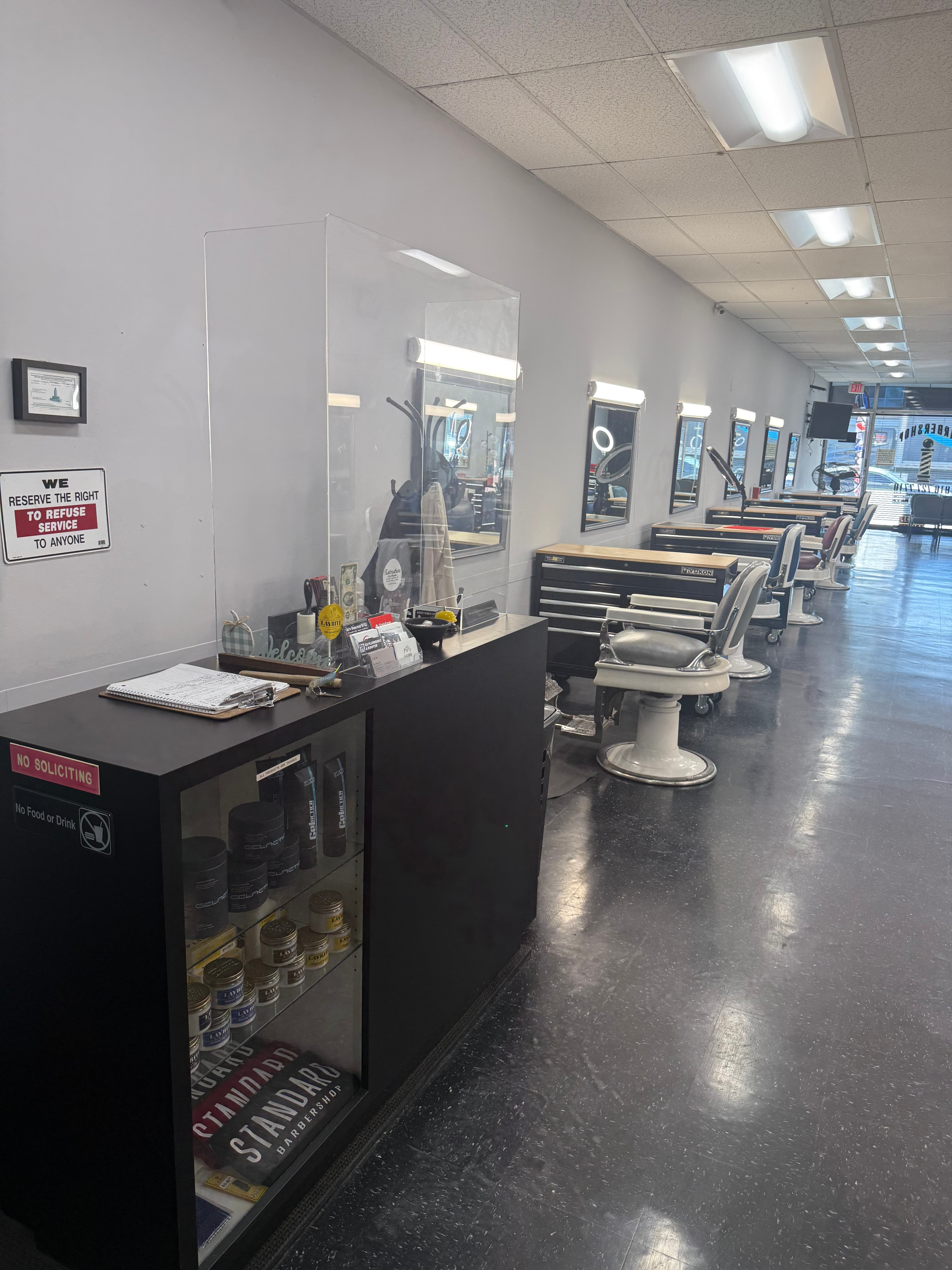 Standard Barbershop interior with barber stations and products